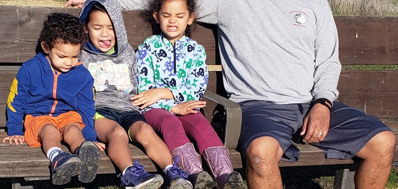 dad and kids on bench