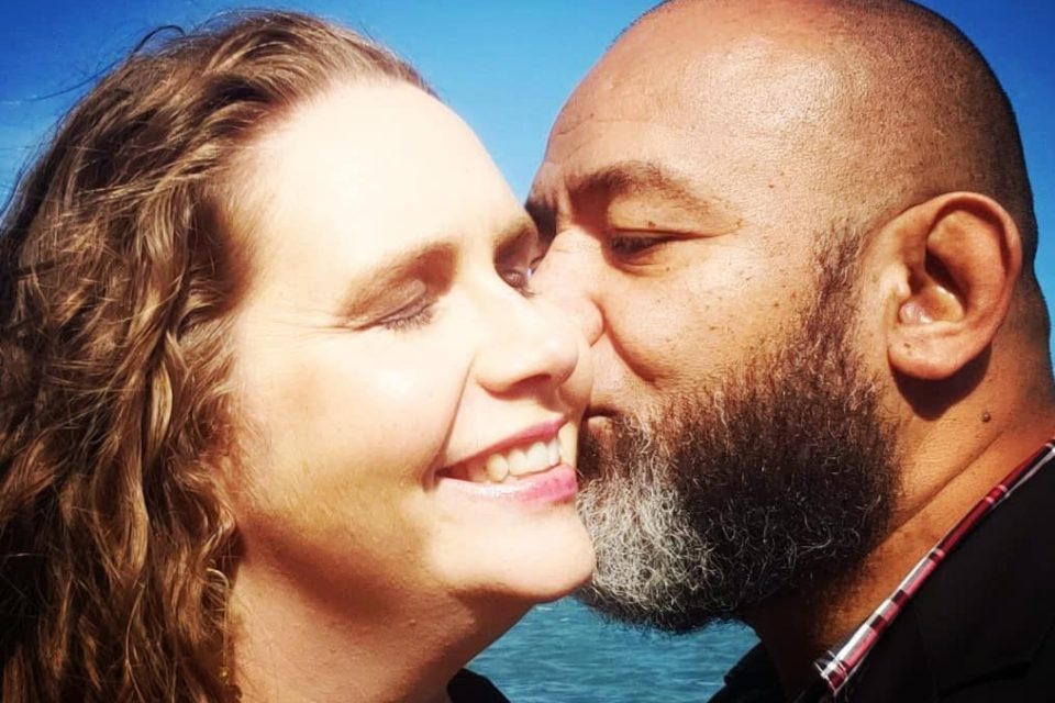 husband kissing wife's cheek