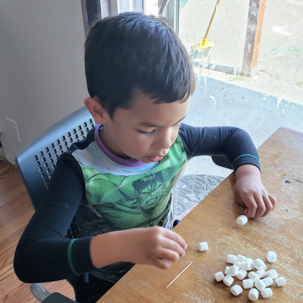 boy playing with marshmallows