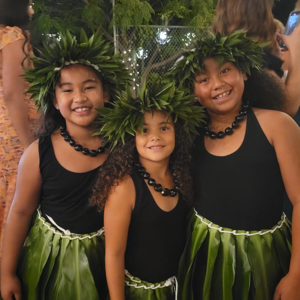 three girls in hula outfits