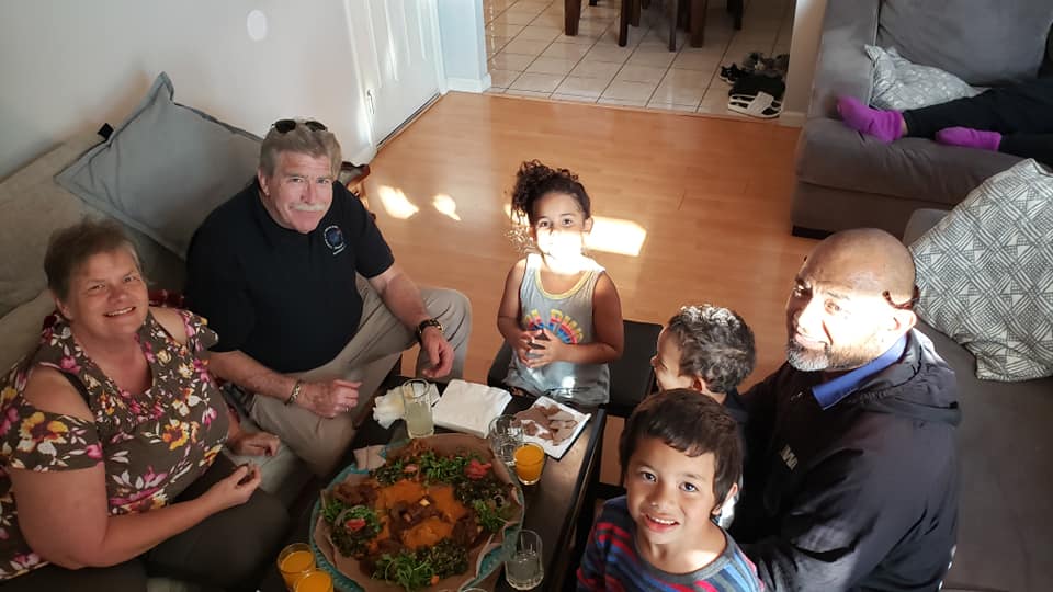family around Eritrean food platter