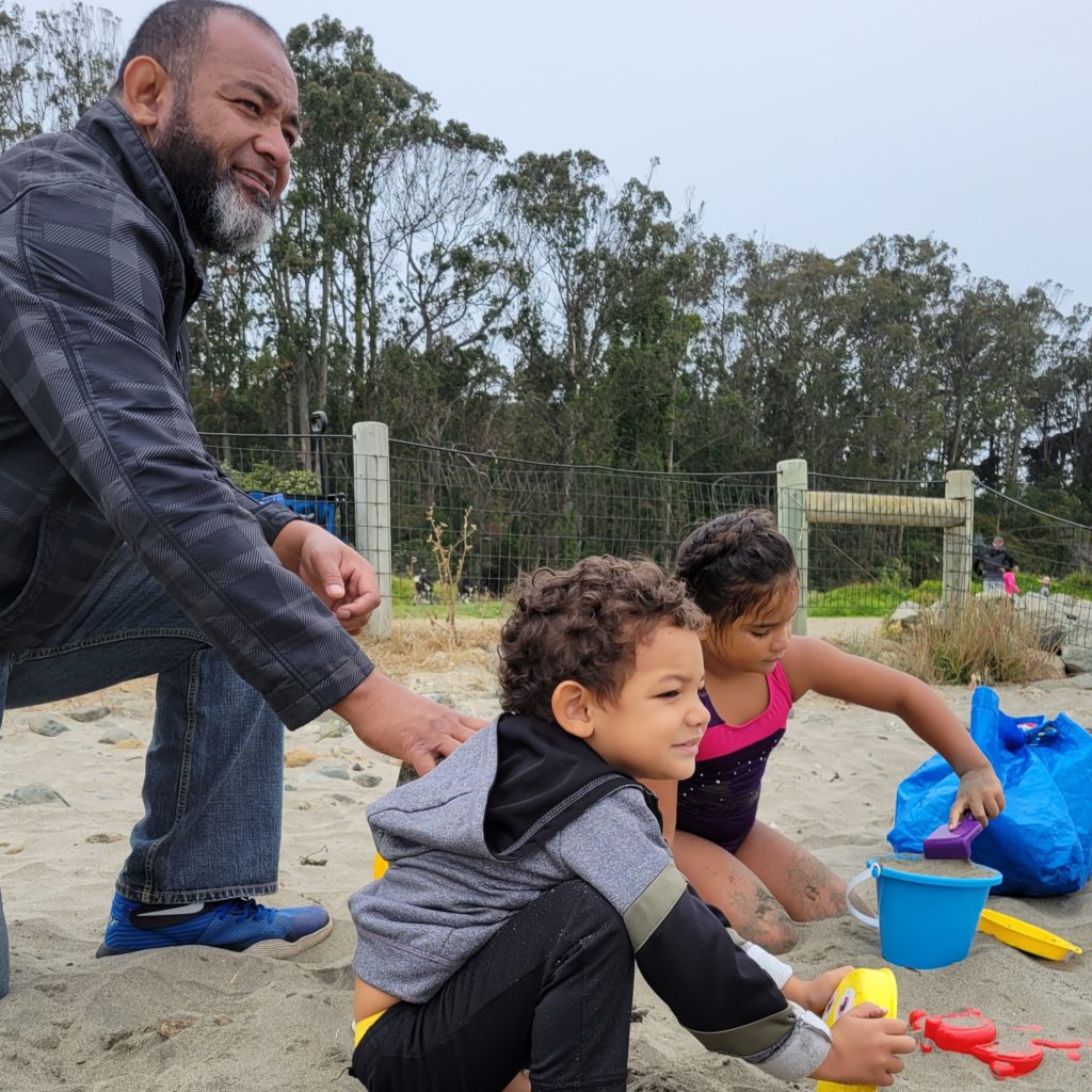 dad and kids at the beach