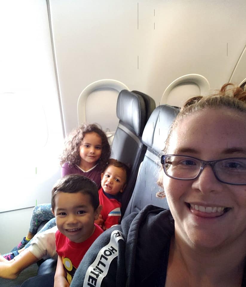 mom and 3 kids on airplane