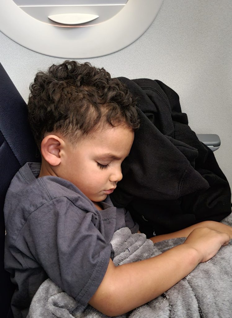 boy asleep on airplane