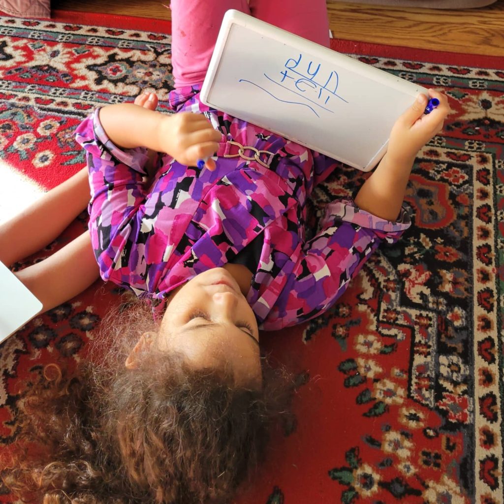 girl writing on white board