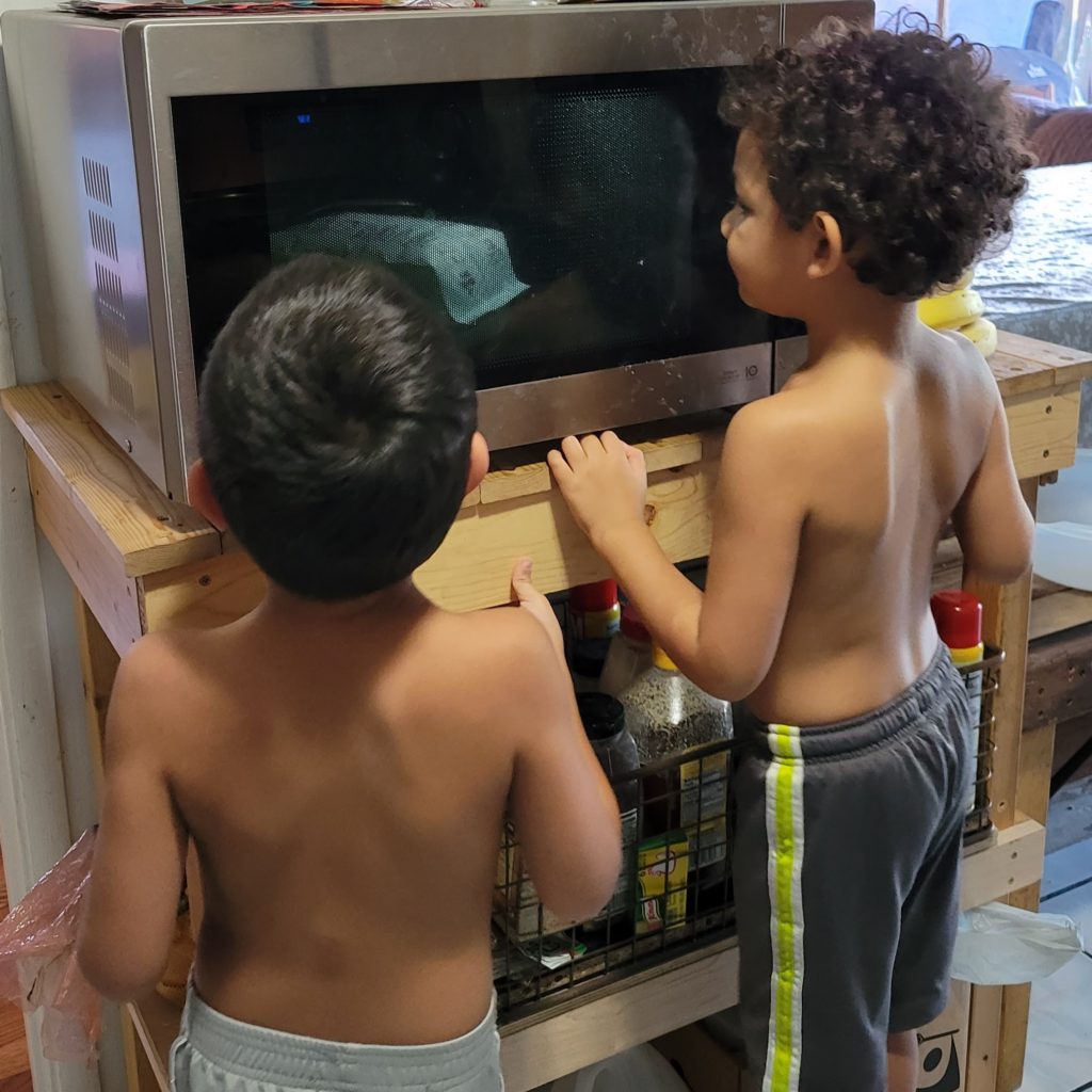 boys in front of microwave