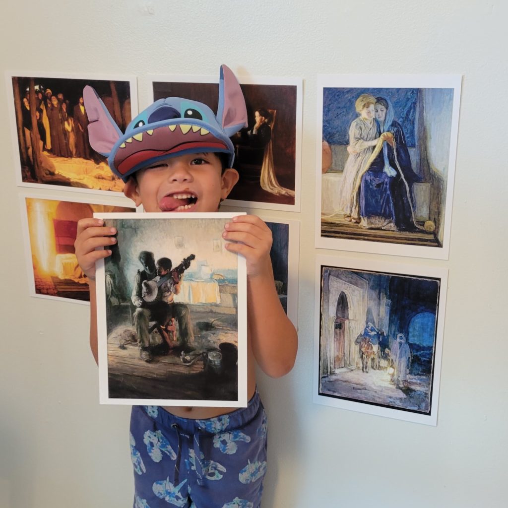 boy standing in front of 7 Tanner prints
