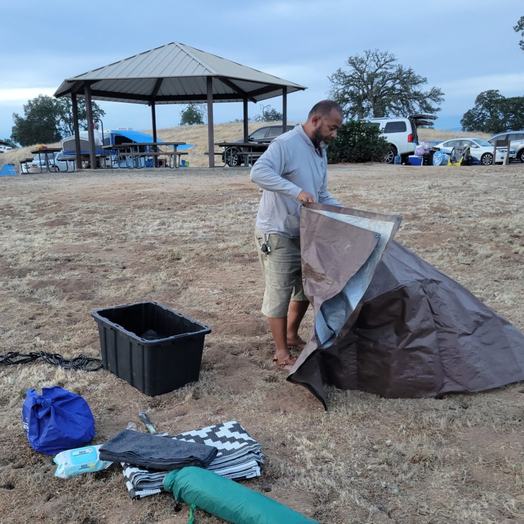 man sets up tent