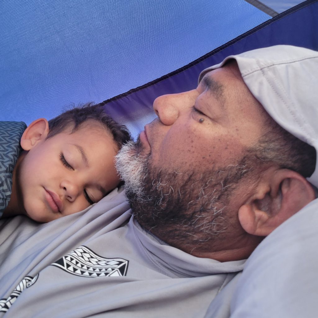 son sleeping on dad's chest