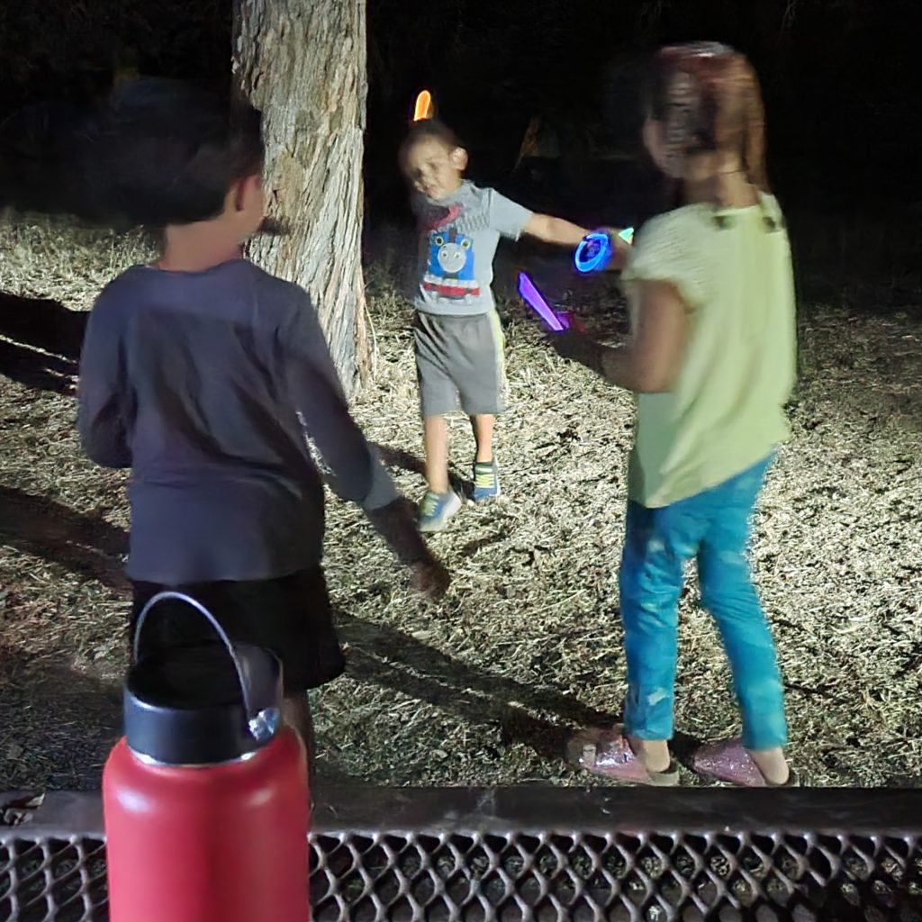 children at night with glow sticks