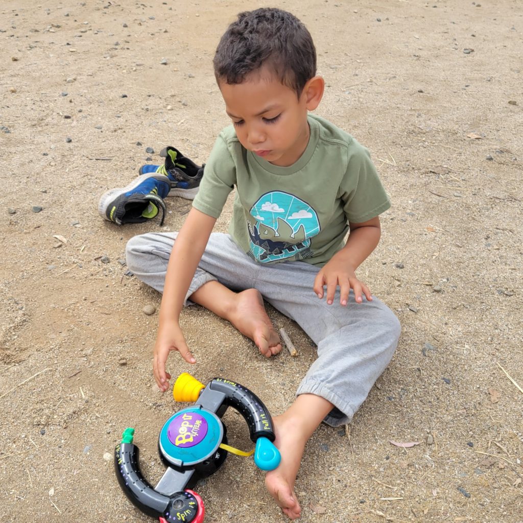 boy on ground with toy