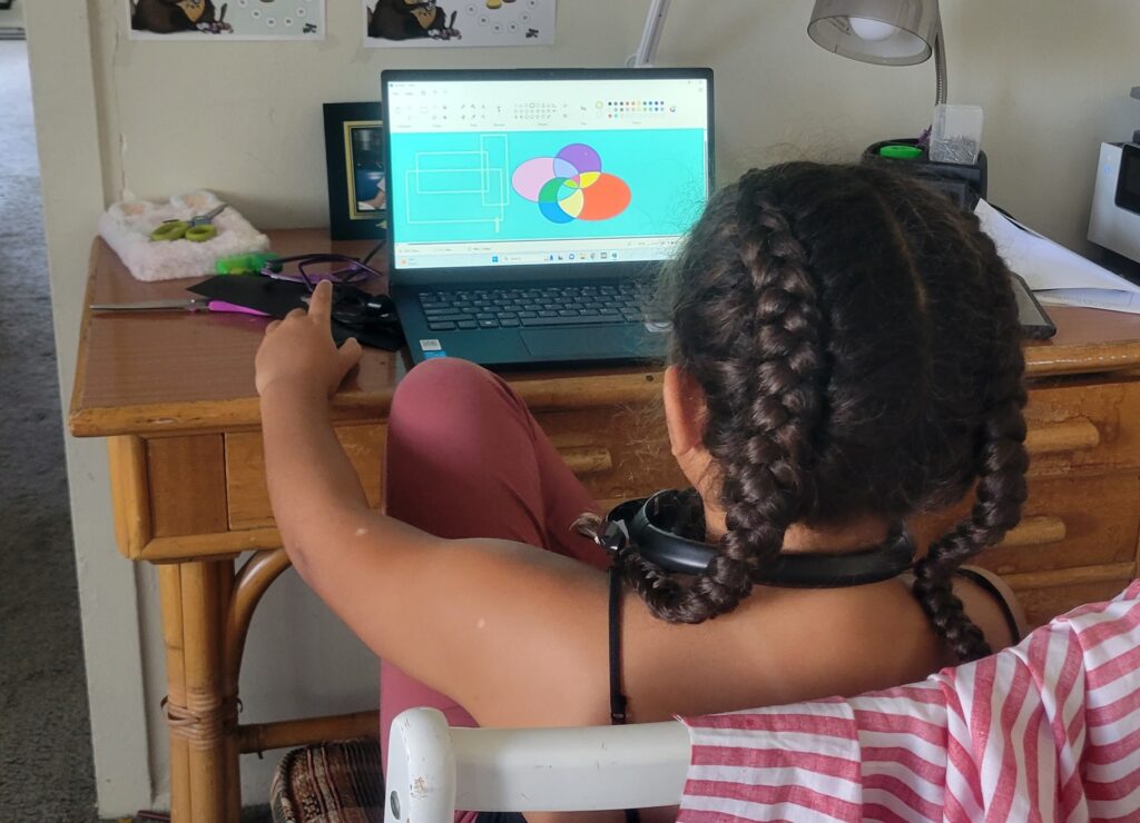 girl at desk with laptop