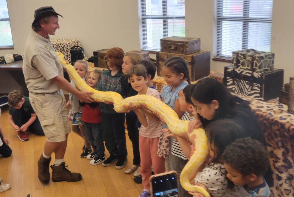 kids holding 12 foot snake