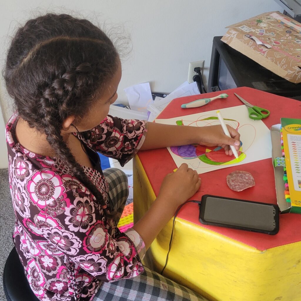 girl coloring and listening to music