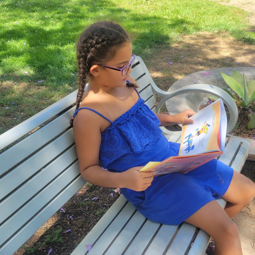 girl on bench reading book