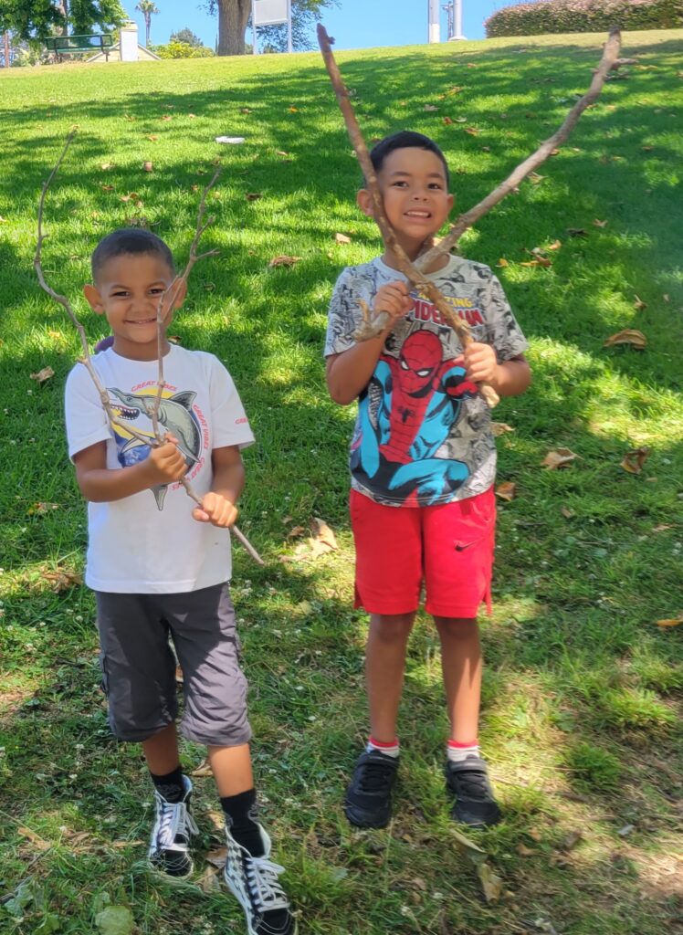 boys outside with sticks