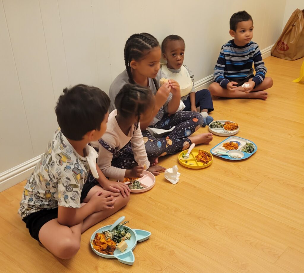 five kids eating on the floor